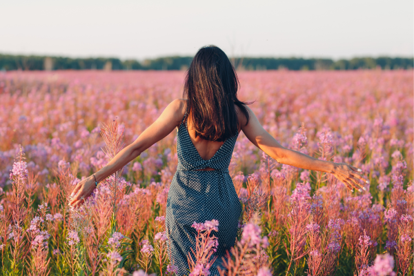 woman walking in beautiful flowers